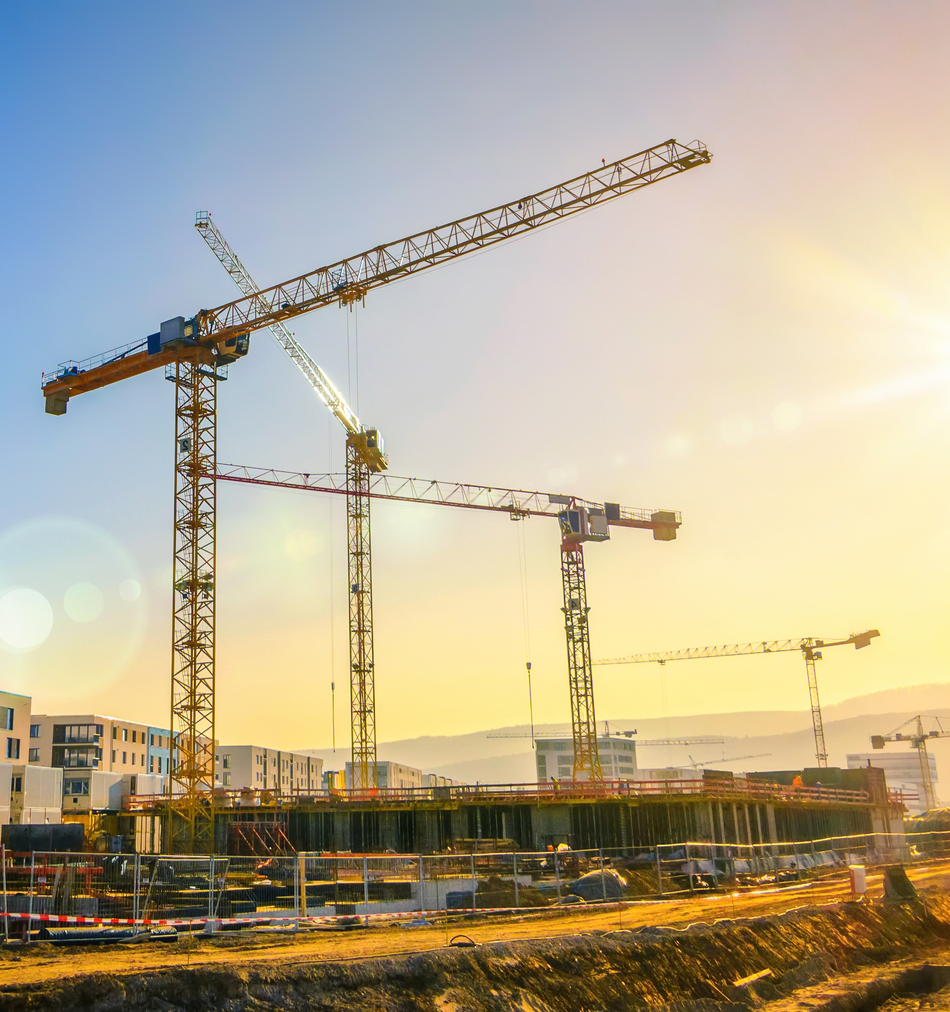 Large,Construction,Site,Including,Several,Cranes,Working,On,A,Building